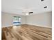 Spacious living area features sleek flooring and sliding glass doors leading to an outdoor space at 1304 N Ferrell St, Plant City, FL 33563