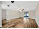 Spacious living room features modern flooring, a ceiling fan, and sliding glass doors to the patio at 1304 N Ferrell St, Plant City, FL 33563