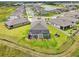 Stunning aerial view of a home with a screened pool and well-manicured lawn in a peaceful neighborhood at 13098 Wellspring Dr, Lithia, FL 33547