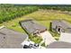 Aerial view showcasing the home's backyard pool, proximity to neighboring houses, and lush surrounding area at 13098 Wellspring Dr, Lithia, FL 33547