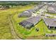 Aerial view of a home with a screened-in pool, lush green lawn, and an outdoor recreational area at 13098 Wellspring Dr, Lithia, FL 33547