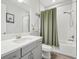 Clean bathroom with a shower-tub combo, neutral gray vanity, and modern fixtures at 13098 Wellspring Dr, Lithia, FL 33547