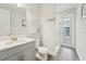 Bathroom featuring gray wood floors, white vanity, modern fixtures, and walk-in shower at 13098 Wellspring Dr, Lithia, FL 33547