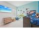 This bedroom features fun colorful wall decor, a tv, and a lofted bed at 13098 Wellspring Dr, Lithia, FL 33547