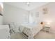 Bright bedroom with a floral quilt bed, desk and chair, and light pink walls at 13098 Wellspring Dr, Lithia, FL 33547