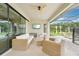 Relaxing covered patio with comfortable seating and a mounted TV, perfect for entertaining and outdoor living at 13098 Wellspring Dr, Lithia, FL 33547