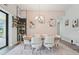 Dining room with modern light fixture, table set for six and bar; large windows at 13098 Wellspring Dr, Lithia, FL 33547