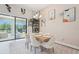 Bright dining area with table for six, modern light fixture, and sliding glass doors to backyard pool at 13098 Wellspring Dr, Lithia, FL 33547