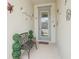 Cozy front entryway with a bench, potted plants, and a decorative front door at 13098 Wellspring Dr, Lithia, FL 33547