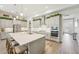 Well-lit kitchen with a large center island, stainless steel microwave and oven, and lots of storage at 13098 Wellspring Dr, Lithia, FL 33547