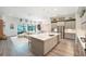 Open kitchen and living area with a large island, stainless steel appliances, and plenty of counter space at 13098 Wellspring Dr, Lithia, FL 33547