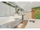 Spacious kitchen with a large island, stainless steel appliances, modern finishes, and custom barn door at 13098 Wellspring Dr, Lithia, FL 33547