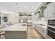 A large center island is the focal point in this well-lit kitchen with stainless steel appliances at 13098 Wellspring Dr, Lithia, FL 33547