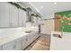 Bright kitchen with a large center island, stainless steel appliances, and custom barn door at 13098 Wellspring Dr, Lithia, FL 33547