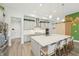 Spacious kitchen with a large island, pendant lighting, stainless steel appliances, and custom barn door at 13098 Wellspring Dr, Lithia, FL 33547