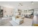 Open-concept living space with a comfortable sofa, a dining area, and a view of the modern kitchen at 13098 Wellspring Dr, Lithia, FL 33547