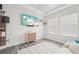 Modern living room featuring a TV, floating shelves, white sofa, and stylish decor at 13098 Wellspring Dr, Lithia, FL 33547