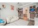 Cozy living room featuring a white sofa, mounted TV, and desk overlooking the kitchen at 13098 Wellspring Dr, Lithia, FL 33547