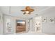 This main bedroom features a tv, a fan, and access to the ensuite bathroom at 13098 Wellspring Dr, Lithia, FL 33547