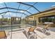 Inviting pool area featuring patio chairs, a grill, and a lounging swing, perfect for relaxation at 13098 Wellspring Dr, Lithia, FL 33547