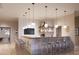 Resident bar with island seating, modern pendant lighting, custom stonework backsplash, and television for entertainment at 13123 Empress Jewel Trl, Parrish, FL 34219
