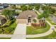 An aerial view of the home highlighting the manicured lawn, landscaping, and neighborhood at 13201 Wellington Hills Dr, Riverview, FL 33579