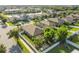 Beautiful aerial view of a neighborhood, showcasing lush trees, nearby lake and well-maintained yards at 13201 Wellington Hills Dr, Riverview, FL 33579