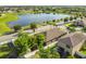 Aerial view of a home with fenced backyard, view of lake and other homes nearby at 13201 Wellington Hills Dr, Riverview, FL 33579