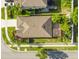 Aerial view of a home with a well-maintained roof, lush landscaping, and an outdoor living space at 13201 Wellington Hills Dr, Riverview, FL 33579