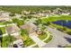 Aerial view of a home with a large driveway, palm trees and lush landscaping at 13201 Wellington Hills Dr, Riverview, FL 33579