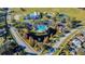 Aerial view of community with large pool, pond with fountain, and mature landscaping at 13201 Wellington Hills Dr, Riverview, FL 33579