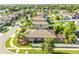 A scenic aerial view showcases a neighborhood with backyard patios, lush landscaping, and well-maintained homes at 13201 Wellington Hills Dr, Riverview, FL 33579