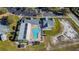 Overhead shot shows community clubhouse and uniquely shaped pool with parking and partially visible tennis court at 13201 Wellington Hills Dr, Riverview, FL 33579
