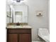Bathroom features a granite countertop, dark wood cabinets, and a decorative wall shelf at 13201 Wellington Hills Dr, Riverview, FL 33579