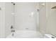 White tiled bathtub and shower combination with chrome hardware at 13201 Wellington Hills Dr, Riverview, FL 33579