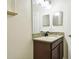 Bathroom vanity with granite countertop, and dark wood cabinets at 13201 Wellington Hills Dr, Riverview, FL 33579