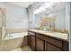 Bathroom featuring double vanity, soaking tub, and tiled shower at 13201 Wellington Hills Dr, Riverview, FL 33579