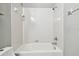 Standard all-white tiled bathtub/shower combination with chrome hardware at 13201 Wellington Hills Dr, Riverview, FL 33579