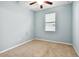 Cozy bedroom with ceiling fan, carpeted floor, and a large window at 13201 Wellington Hills Dr, Riverview, FL 33579