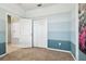 Bedroom featuring a color block paint design and bi-fold closet doors at 13201 Wellington Hills Dr, Riverview, FL 33579