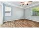 Light-filled bedroom with wood-look flooring and a ceiling fan at 13201 Wellington Hills Dr, Riverview, FL 33579