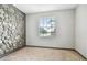 Bedroom featuring a window with blinds and an accent wall with stonework at 13201 Wellington Hills Dr, Riverview, FL 33579