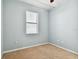 This bedroom has neutral carpeting, bright natural light, and light blue walls at 13201 Wellington Hills Dr, Riverview, FL 33579