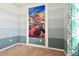 Cozy bedroom featuring marine life accent wall and a window with curtains at 13201 Wellington Hills Dr, Riverview, FL 33579