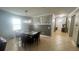 Formal dining area featuring a stylish light fixture, a large table with seating for six, and access to the hallway at 13201 Wellington Hills Dr, Riverview, FL 33579