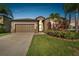 Well-maintained single Gathering home with a two-car garage and vibrant landscaping at 13201 Wellington Hills Dr, Riverview, FL 33579