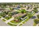 Stunning single-Gathering home featuring a well-manicured lawn, mature palm trees, and a private fenced backyard at 13201 Wellington Hills Dr, Riverview, FL 33579