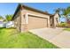 This one-story home has a neutral siding, well-manicured grass and a two-car garage at 13201 Wellington Hills Dr, Riverview, FL 33579