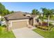 Charming single-Gathering home with two-car garage, lush landscaping, and well-manicured lawn at 13201 Wellington Hills Dr, Riverview, FL 33579