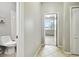 Neutral hallway leading into a bedroom with natural light coming in at 13201 Wellington Hills Dr, Riverview, FL 33579